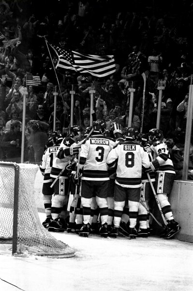 FILE - In this Feb. 22, 1980, file photo, U.S. ice hockey players celebrate after a first period goal by Buzz Schneider against the Soviet Union at the Winter Olympics in Lake Placid, N.Y.  (AP Photo/File)
