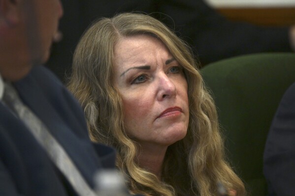 Lori Vallow Daybell sits during her sentencing hearing at the Fremont County Courthouse in St. Anthony, Idaho, Monday, July 31, 2023. Idaho mother Vallow Daybell has been sentenced to life in prison without parole Monday in the murders of her two youngest children and a romantic rival in a case that included bizarre claims that her son and daughter were zombies and that she was a goddess sent to usher in the Biblical apocalypse. (Tony Blakeslee/EastIdahoNews.com via AP, Pool)