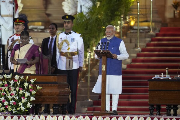 Narendra Modi, right, is sworn-in as the Prime Minister of India by President Droupadi Murmu, left, at the Rashtrapati Bhawan, in New Delhi, India, Sunday, June 9, 2024. The 73-year-old leader is only the second Indian prime minister to retain power for a third term. (AP Photo/Manish Swarup)