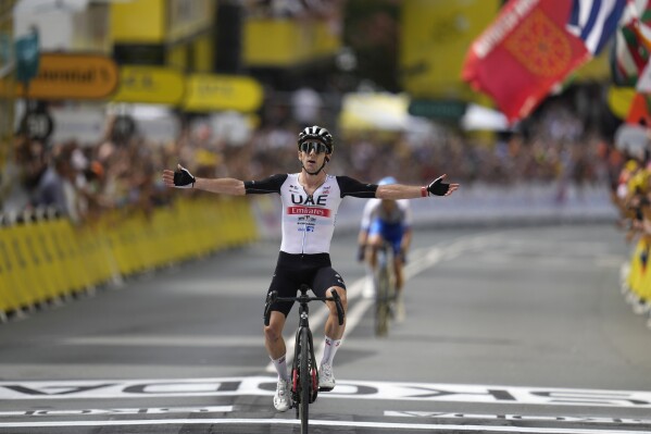 Britain's Adam Yates celebrates after crossing the finish line of the first stage of the Tour de France cycling race over 182 kilometers (113 miles) with start and finish in Bilbao, Spain, Saturday, July 1, 2023. (AP Photo/Thibault Camus)