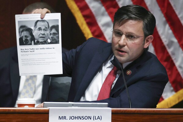 FILE - Rep. Mike Johnson, R-La., holds up an article while questioning Attorney General William Barr during a House Judiciary Committee hearing on the oversight of the Department of Justice on Capitol Hill, July 28, 2020 in Washington. Johnson, the new leader of one of the houses of Congress that will certify the winner of next year's presidential election helped spearhead the attempt to overturn the last one. (Chip Somodevilla/Pool via AP, File)