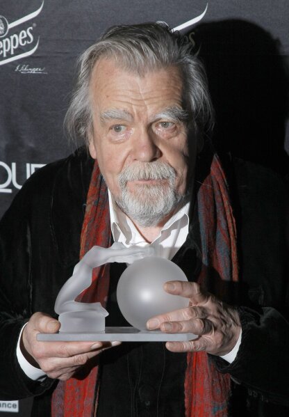 FILE - In this Feb.7, 2011 file photo, actor Michael Lonsdale poses after receiving a Crystal Globe award of best actor during the Crystal Globes awards ceremony, in Paris. Michael Lonsdale, a French-British actor and giant of the silver screen and theatre in France, died on Monday, his agent said. From his role as villain in the 1979 James Bond film "Moonraker" to that of a monk in Algeria in "Of Gods and Men," Lonsdale worked, often in second roles, with top directors from Orson Wells to Spielberg.(AP Photo/Jacques Brinon, File)