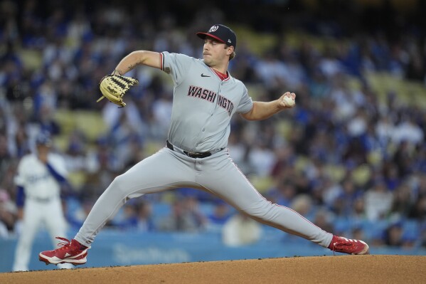 Washington Nationals starting pitcher Mitchell Parker throws to a Los Angeles Dodgers batter during the first inning of a baseball game Monday, April 15, 2024, in Los Angeles. (AP Photo/Marcio Jose Sanchez)