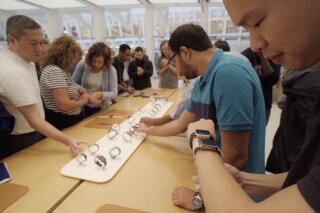 
              FILE- In this Sept. 21, 2018 file photo customers look at Apple Watches at an Apple store in New York. A huge study suggests the Apple Watch sometimes can detect a worrisome irregular heartbeat. But experts say more work is needed to tell if using wearable technology to screen for heart problems really helps.  (AP Photo/Patrick Sison, File)
            