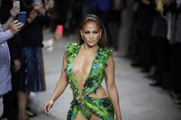 Actress Jennifer Lopez wears a creation as part of the Versace Spring-Summer 2020 collection, unveiled during the fashion week, in Milan, Italy, Friday, Sept. 20, 2019. (AP Photo/Luca Bruno, File)