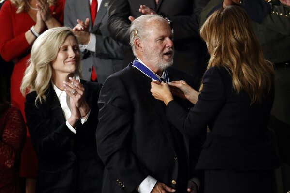 First Lady Melania Trump presents the Presidential Medal of Freedom to Rush Limbaugh as his wife Kathryn watches during the State of the Union address to a joint session of Congress on Capitol Hill in Washington, Tuesday, Feb. 4, 2020. (AP Photo/Patrick Semansky)
