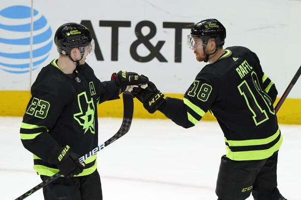 Dallas Stars left wing Michael Raffl (18) is congratulated by teammate Esa Lindell (23) after Raffle score a goal during the second period of an NHL hockey game against the Buffalo Sabres in Dallas, Sunday, Feb. 27, 2022. (AP Photo/LM Otero)