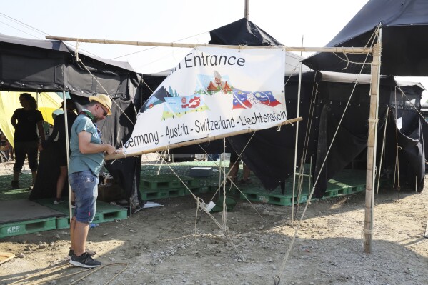 Attendees of the World Scout Jamboree prepare to leave a scout camping site in Buan, South Korea, Monday, Aug. 7, 2023. South Korea will evacuate tens of thousands of scouts by bus from a coastal jamboree site as Tropical Storm Khanun looms, officials said Monday. (Na Bo-bae/Yonhap via AP)