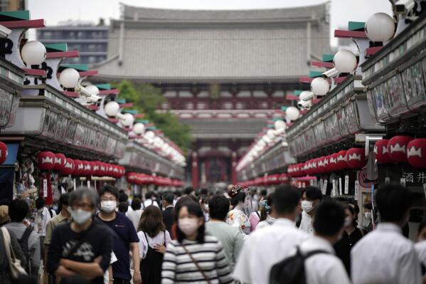 FILE - Visitors walk along a shopping street at the Asakusa district on June 10, 2022, in Tokyo. Individual travelers will be able to visit Japan without visas beginning Tuesday, Oct. 11, just like in pre-COVID-19 times. (AP Photo/Eugene Hoshiko, File)