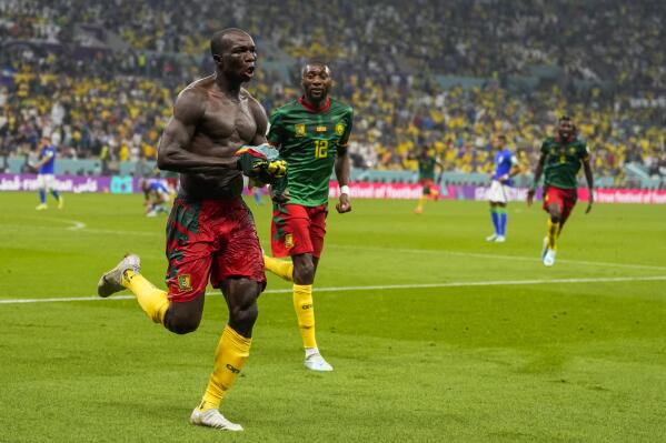 Cameroon's Vincent Aboubakar, left, celebrates after scoring the opening goal during the World Cup group G soccer match between Cameroon and Brazil, at the Lusail Stadium in Lusail, Qatar, Friday, Dec. 2, 2022. (AP Photo/Andre Penner)