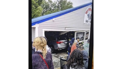 In this photo released by the Laconia Fire Department, a vehicle sits inside a restaurant after crashing through the wall on Sunday, July 2, 2023, in Laconia, NH.  The car struck the busy Looney Bin Bar & Grill and injured more than a dozen patrons inside, authorities said.  (Laconia Fire Department via AP)