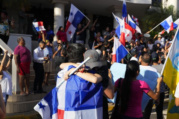 Los manifestantes celebran al enterarse de que la Corte Suprema de Panamá declaró inconstitucional una concesión de 20 años para una mina de cobre canadiense que había provocado semanas de protestas, en la Ciudad de Panamá, el martes 28 de noviembre de 2023. (AP Foto/Arnulfo Franco)