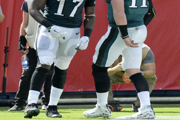 
              Philadelphia Eagles quarterback Carson Wentz (11) celebrates with wide receiver Alshon Jeffery (17) after they combined on a 16-yard touchdown pass against the Tennessee Titans in the second half of an NFL football game Sunday, Sept. 30, 2018, in Nashville, Tenn. (AP Photo/Mark Zaleski)
            