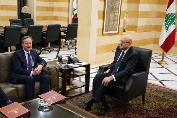 Britain's Foreign Secretary David Cameron, left, meets with Lebanese caretaker Prime Minister Najib Mikati in Beirut, Lebanon, Thursday, Feb. 1, 2024. Cameron discussed with Lebanese officials the volatile situation in the Middle East during a stop in Beirut, part of a regional tour. (AP Photo/Bilal Hussein)