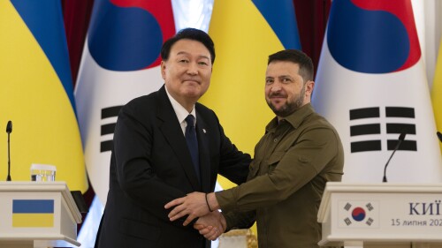 South Korean President Yoon Suk Yeol, left, and Ukrainian President Volodymyr Zelenskyy stand for photos after delivering statements, Saturday, July 15, 2023, in Kyiv, Ukraine. (AP Photo/Jae C. Hong)