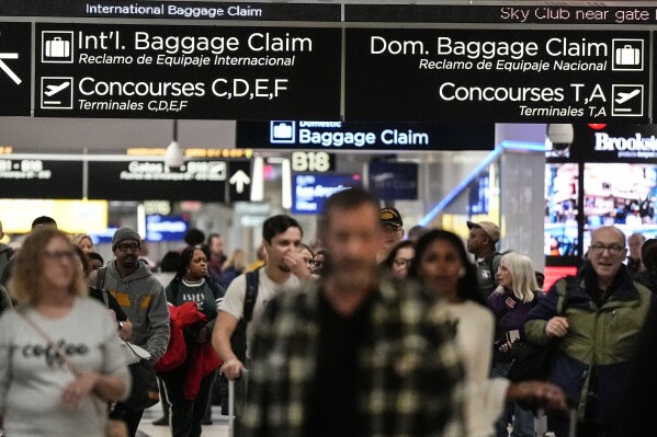 Travelers move through the B terminal at Hartsfield-Jackson Atlanta International Airport, Saturday, Jan. 27, 2024, in Atlanta. On Tuesday, Feb. 27, 2024, the Conference Board reports on U.S. consumer confidence for February. (AP Photo/Mike Stewart)