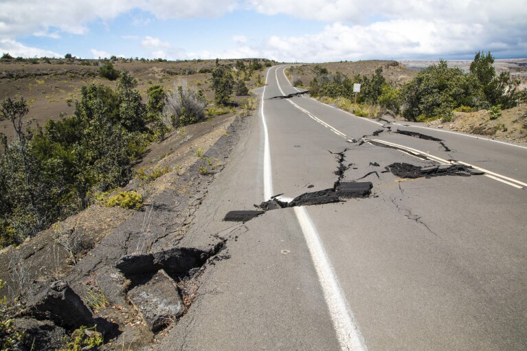 FILE - This photo provided by the National Park Service shows earthquake damage to Crater Rim Drive inside Hawaii Volcanoes National Park in Hawaii on Friday, Aug. 17, 2018. (Janice Wei/National Park Service via AP, File)