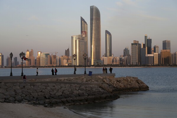 With the city skyline in backdrop, people of different nationalities enjoy a good weather of 24 degrees Celsius (75.2 degrees Fahrenheit) n Abu Dhabi, United Arab Emirates, Wednesday, Jan. 14, 2015. (AP Photo/Kamran Jebreili, File)