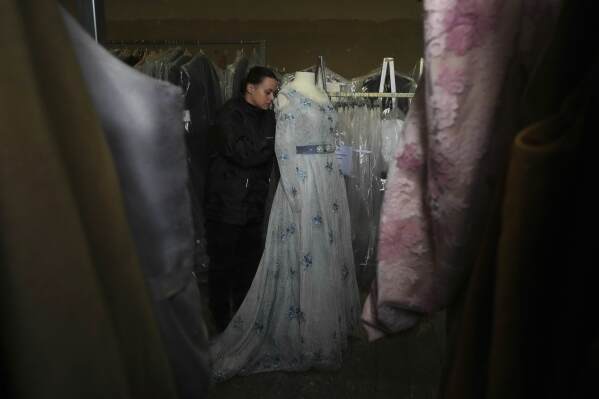 A tailor works on a stage costume for Giacomo Puccini's "Tosca" opera in the "Teatro dell' Opera" opera house costumes warehouse, in Rome, Thursday, April 10, 2025. (AP Photo/Andrew Medichini)