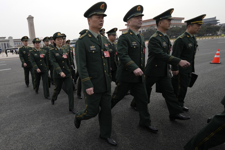 Chinese military officers arrive for a preparatory session of the Chinese National People's Congress outside the Great Hall of the People in Beijing, Monday, March 4, 2024. (AP Photo/Ng Han Guan)