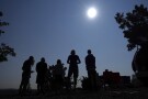 FILE - People gather near Redmond, Ore., to view the sun as it nears a total eclipse by the moon, Monday, Aug. 21, 2017. The April 8, 2024 total solar eclipse in North America first hits land at Mexico’s Pacific coast, cuts diagonally across the U.S. from Texas to Maine and exits in eastern Canada. (AP Photo/Ted S. Warren, File)