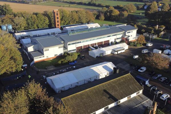 A view of the Manston immigration short-term holding facility located at the former Defence Fire Training and Development Centre is pictured in Manston, England, Monday Oct. 31, 2022. 700 people were moved to the Manston facility for safety reasons after incendiary devices were thrown at a Border Force migrant centre in Dover on Sunday. (Gareth Fuller/PA via AP)