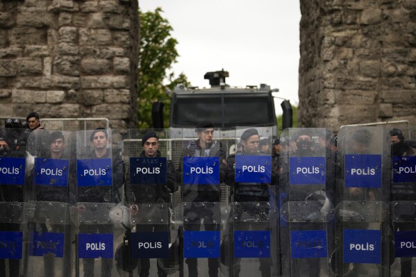 Anti riot police officers stand guard blocking the route to protesters as Union members march during Labor Day celebrations in Istanbul, Turkey, Wednesday, May 1, 2024. Police in Istanbul detained dozens of people who tried to reach the city's main square, Taksim, in defiance of a government ban on celebrating May 1 Labor Day at the landmark location. (AP Photo/Emrah Gurel)