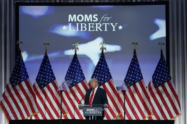 FILE - Former President Donald Trump speaks at the Moms for Liberty meeting in Philadelphia, June 30, 2023. Moms for Liberty says it has removed two Kentucky chapter chairs from their leadership roles after they posed in photos with members of the far-right group the Proud Boys, one of several controversies the conservative 鈥減arental rights鈥� nonprofit has fended off in its polarizing rise to prominence in public schools across the country. (APPhoto/Matt Rourke, File)