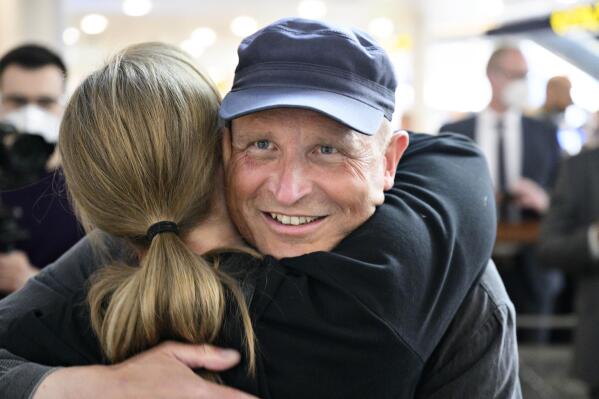 Danish Jehovah’s Witness, Dennis Christensen, hugs an unidentified woman upon his return at Copenhagen's airport, Wednesday, May 24, 2022. Christensen has returned to Denmark after spending five years in a Russian prison under Moscow’s crackdown on the religious group which was officially banned in Russia in 2017. Christensen, a 49-year-old Dane, was arrested that year for leading a prayer meeting, and was handed a six-year prison sentence in 2019.  (Philip Davali/Ritzau Scanpix via AP)