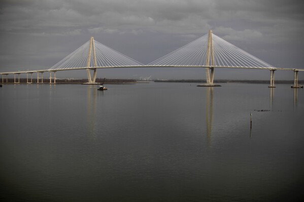 FILE - The Arthur Ravenel Jr. Bridge, concocting Mount Pleasant, S.C., right, to Charleston, S.C., is seen, Jan. 17, 2012. The bridge was closed Wednesday, June 5, 2024, after a large cargo ship lost control and was going full throttle underneath it. (AP Photo/Matt Rourke, File)