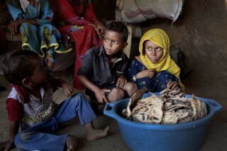 
              FILE - In this Oct. 1, 2018 file photo, children sit in front of moldy bread in their shelter, in Aslam, Hajjah, Yemen. The U.N. Office for the Coordination of Humanitarian Affairs, or OCHAU.N. warned in a report Tuesday, March 12, 2019, that thousands of Yemeni civilians caught in fierce clashes between warring factions are trapped in the embattled northern district of Hajjah. The number of displaced in the district has doubled over the past six months, the humanitarian agency said. (AP Photos Hani Mohammed, File)
            