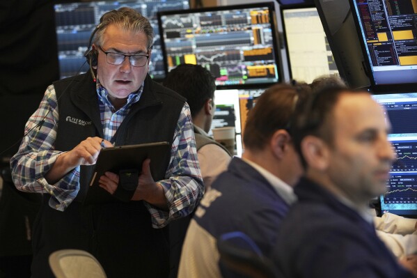 Traders work on the floor at the New York Stock Exchange in New York, Thursday, April 3, 2025. (AP Photo/Seth Wenig)
