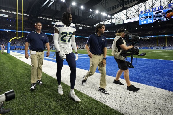 Seattle Seahawks cornerback Riq Woolen (27) walks to the locker room after getting injured during the first half of an NFL football game against the Detroit Lions, Sunday, Sept. 17, 2023, in Detroit. (AP Photo/Paul Sancya)