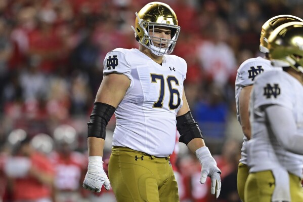FILE - Notre Dame offensive lineman Joe Alt lines up during the fourth quarter of an NCAA college football game against the Ohio State, Saturday, Sept. 3, 2022, in Columbus, Ohio. Joe Alt was named to The Associated Press preseason All-America team, Monday, Aug. 21, 2023. (AP Photo/David Dermer, File)