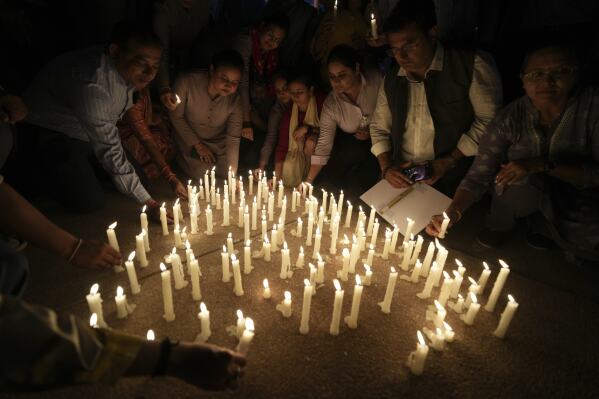 People place candles after a march against the killing of tourists by militants near Pahalgam in Indian controlled Kashmir, in Ahmedabad, India, Thursday, April 24, 2025. (AP Photo/Ajit Solanki)