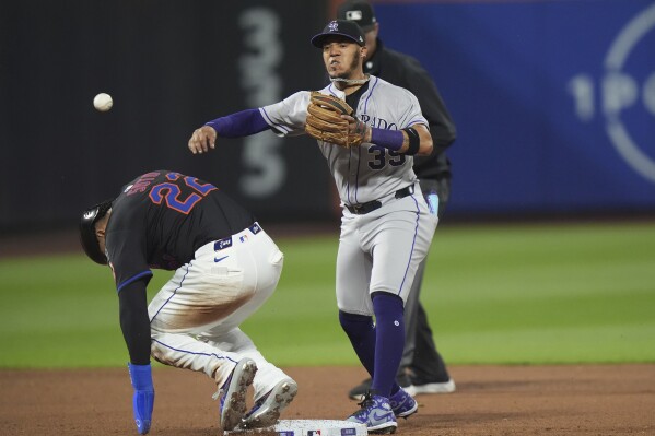 Colorado Rockies' Thairo Estrada, right, throws out New York Mets' Pete Alonso at first base after forcing out Juan Soto, left, for a double play during the sixth inning of a baseball game Friday, May 30, 2025, in New York. (AP Photo/Frank Franklin II)