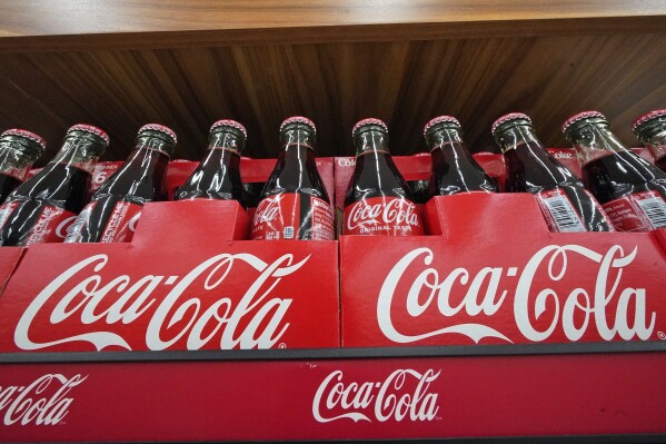 Bottles of Coca-Cola are on display at a grocery market in Uniontown, Pa, on Sunday, April 24, 2022. Coca-Cola reports earnings on Tuesday, Oct. 24, 2023. (AP Photo/Gene J. Puskar)