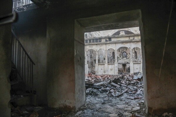 An inside view of a burnt church after a wildfire in a village near the northeastern town of Alexandroupolis, Greece, Sunday, Aug. 20, 2023. Greek authorities on Saturday evacuated eight villages near the northeastern border with Turkey, where a large summer wildfire was burning out of control, whipped on by high winds. (Ilias Kotsireas/InTime News via AP)
