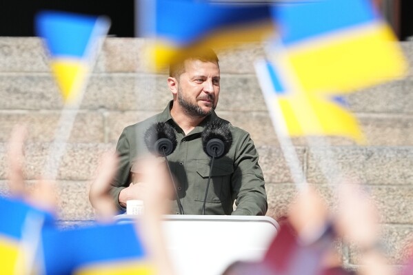 Ukrainian President Volodymyr Zelenskyy addresses the Danish people from the steps of Christiansborg palace, the seat of Danish Parliament, in Copenhagen, Denmark, Monday, Aug. 21, 2023. Thousands of people had gathered in the palace courtyard to hear his speech, many waving Ukrainian or Danish flags. (Mads Claus Rasmussen/Ritzau Scanpix via AP)