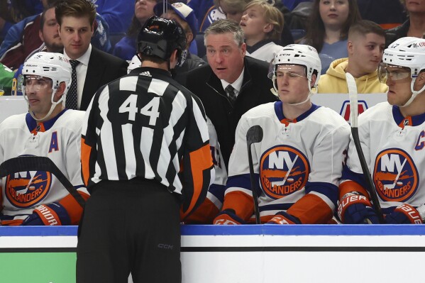 New York Islanders coach Patrick Roy talks with referee Justin Kea (44) during the second period of the team's NHL hockey game against the Buffalo Sabres on Thursday, March 14, 2024, in Buffalo, N.Y. (AP Photo/Jeffrey T. Barnes)