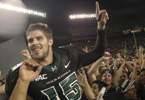 FILE - In this Nov. 23, 2007, file photo, then-Hawaii quarterback Colt Brennan celebrates after an NCAA college football game in Honolulu. Brennan, a star quarterback at the University of Hawaii who finished third in the 2007 Heisman Trophy balloting, died early Tuesday, May 11, 2021, his father said. He was 37. Brennan, who has had public struggles with alcohol, died at a hospital in California, his father, Terry Brennan, told The Associated Press. (AP Photo/Ronen Zilberman, File)