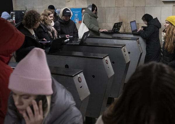 People work in the subway station being used as a bomb shelter during a rocket attack in Kyiv, Ukraine, Monday, Dec. 5, 2022. Ukraine’s air force said it shot down more than 60 of about 70 missiles that Russia fired on in its latest barrage against Ukraine. It was the latest onslaught as part of Moscow’s new, stepped-up campaign that has largely targeted Ukrainian infrastructure and disrupted supplies of power, water and heat in the country as winter looms. (AP Photo/Andrew Kravchenko)