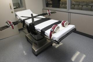 FILE - This photo shows the gurney in the the execution chamber at the Oklahoma State Penitentiary in McAlester, Okla., on Oct. 9, 2014. A federal judge in Oklahoma on Monday, June 6, 2022, ruled the state's three-drug lethal injection method is constitutional, paving the way for the state to request execution dates for more than two dozen death row inmates who were plaintiffs in the case. (AP Photo/Sue Ogrocki, File)