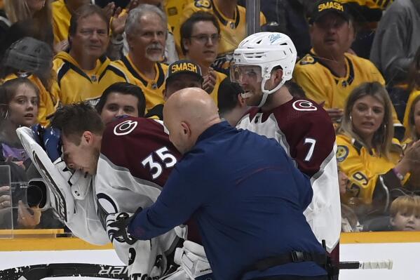Colorado Avalanche goaltender Darcy Kuemper (35) is helped off the ice after getting injured during the first period in Game 3 of an NHL hockey Stanley Cup first-round playoff series against the Nashville Predators Saturday, May 7, 2022, in Nashville, Tenn. (AP Photo/Mark Zaleski)