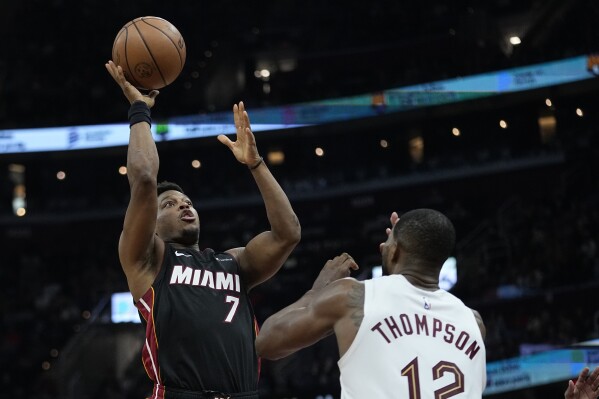 Miami Heat guard Kyle Lowry (7) shoots over Cleveland Cavaliers center Tristan Thompson (12) during the second half of an NBA basketball game Wednesday, Nov. 22, 2023, in Cleveland. (AP Photo/Sue Ogrocki)