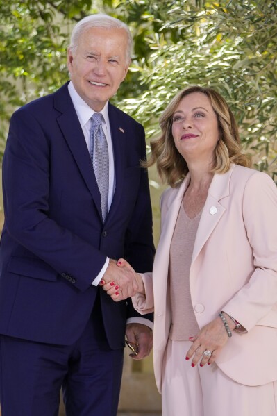 U.S. President Joe Biden, left, is welcomed by Italian Prime Minister Giorgia Meloni during a G7 world leaders summit at Borgo Egnazia, Italy, Thursday, June 13, 2024. (AP Photo/Luca Bruno)