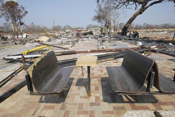 FILE - Only the benches remain at what was a Waffle House restaurant on the beachfront area in Gulfport, Miss., Sept. 20, 2005, following Hurricane Katrina. (AP Photo/Ric Feld, File)