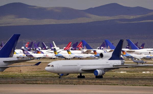FILE - In this March 25, 2020, file photo, passenger and cargo aircraft are seen stored at Southern California Logistics Airport, in Victorville, Calif. (AP Photo/Mark J. Terrill, File)