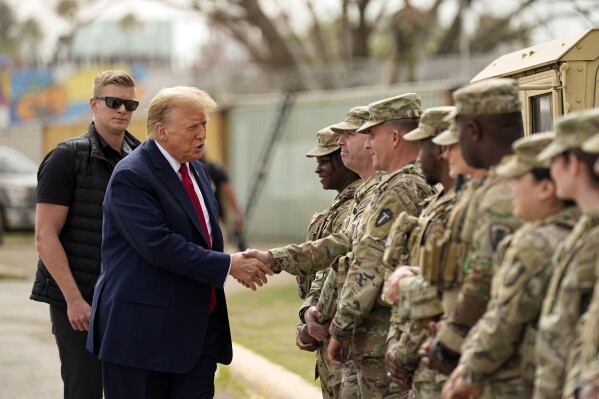 FILE - Republican presidential candidate former President Donald Trump greets members of the National Guard on the U.S.-Mexico border, Feb. 29, 2024, in Eagle Pass, Texas. Recent statements by Trump have fueled Democrats' sense that there's an opening among voters with strong military ties, and progressive veterans' organizations are working to bridge the gap with what has long been a reliably red constituency. (AP Photo/Eric Gay, File)