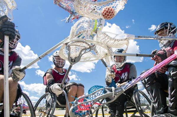 The Colorado Rolling Mammoth touch off to take on the Milwaukee Eagles in the U.S. wheelchair lacrosse national championship at Wheel Park on Saturday, Aug. 27, 2022, in Aurora, Colo. (Kevin J. Beatty/Colorado Public Radio via AP)